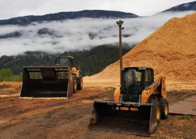 Wheel Loader with Bucket and Skid Steer Loader at Woodchip Stockpile